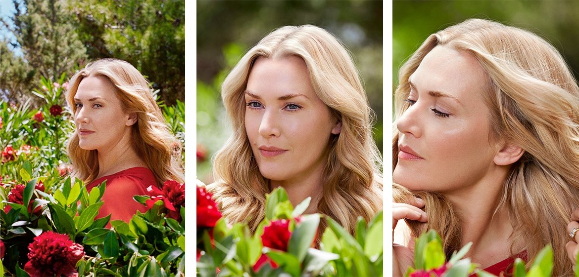 Kate Winslet im Grünen zwischen roten Blumen